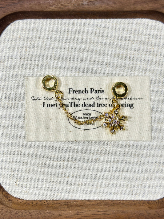 Bright gold snowflake trickle safety chain