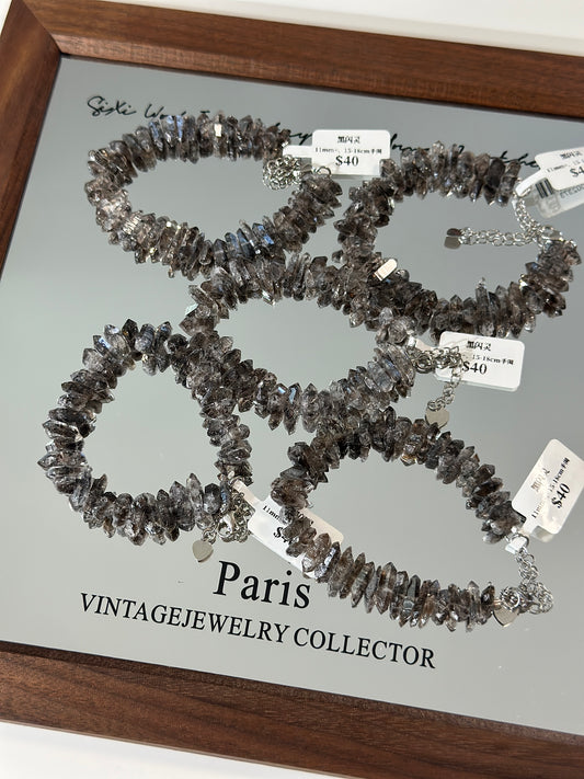 Double-pointed black sparkling crystal