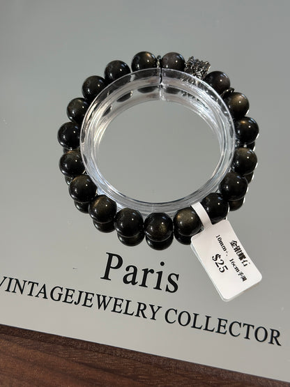 Gold, silver and obsidian design